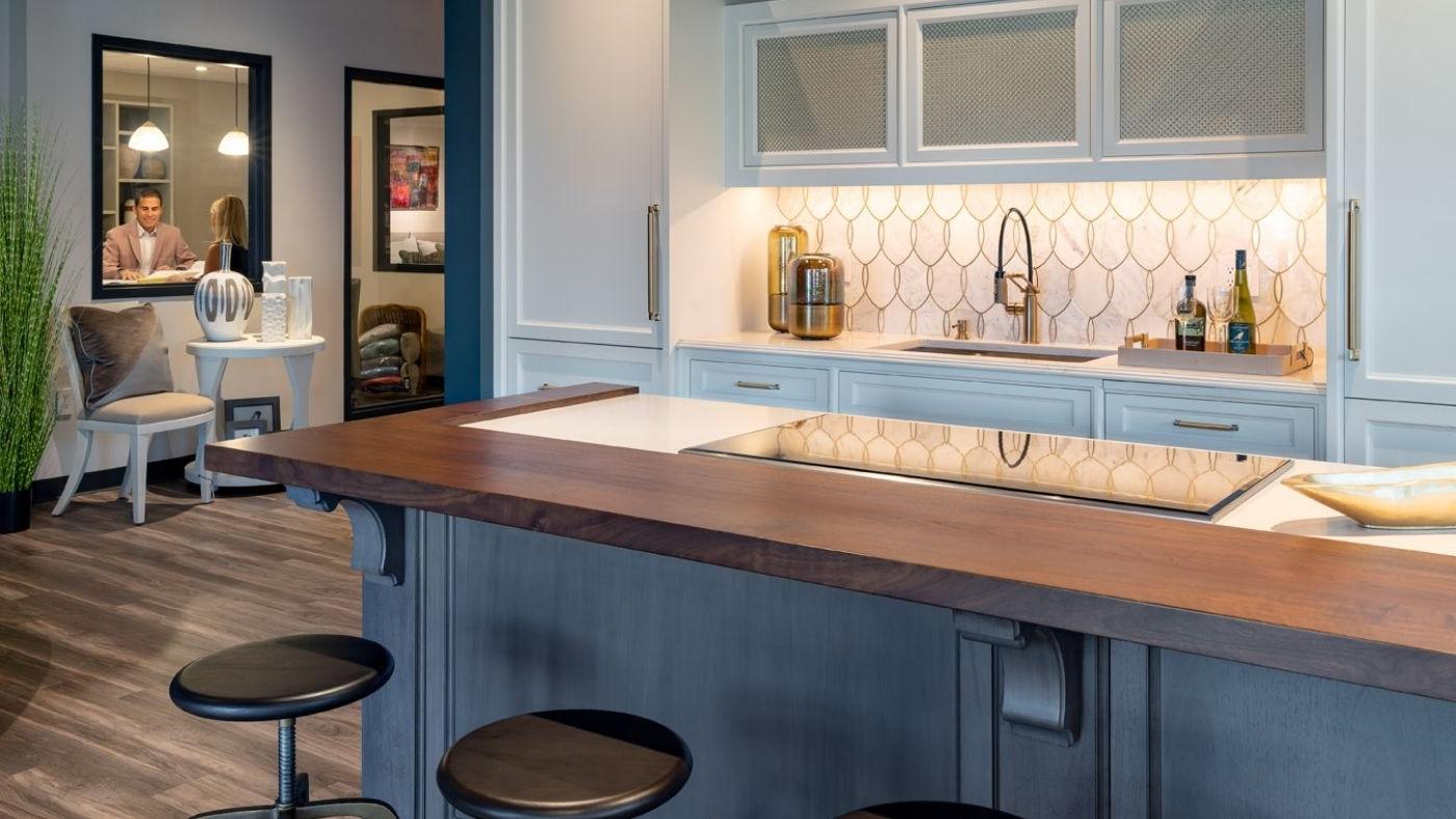 View of a sample kitchen with blue accents in Interiology design center